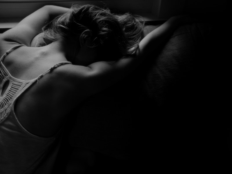 black and white photo of woman laying prone and in pain